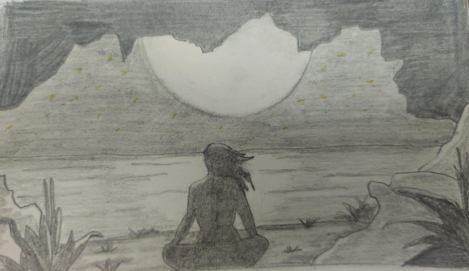 The silhouette of a woman sits in a cave over looking a bright full moon over a body of water.